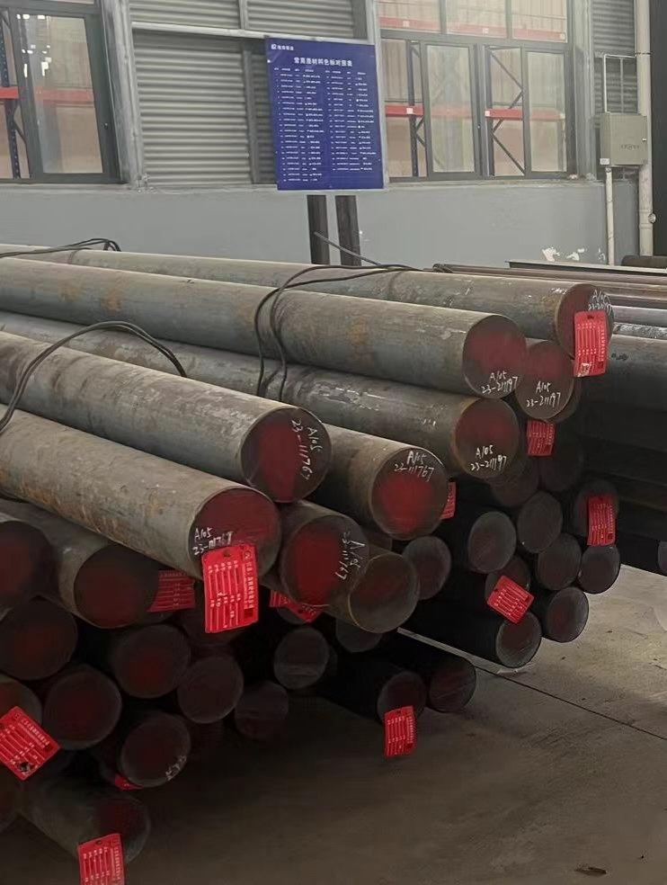 Incoming steel bars tagged with grade and heat number, awaiting inspection