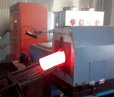 Steel billet heated to forging temperature inside an electric furnace
