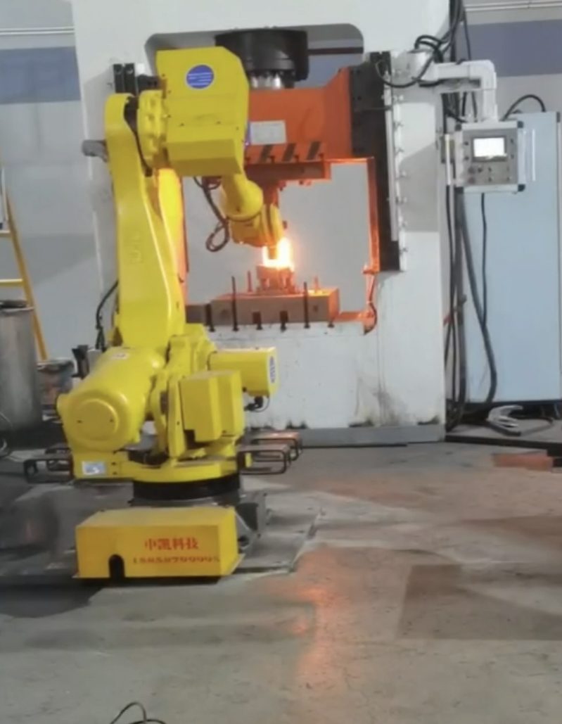 Robotic manipulator transferring a red-hot billet into the multi-directional forging press