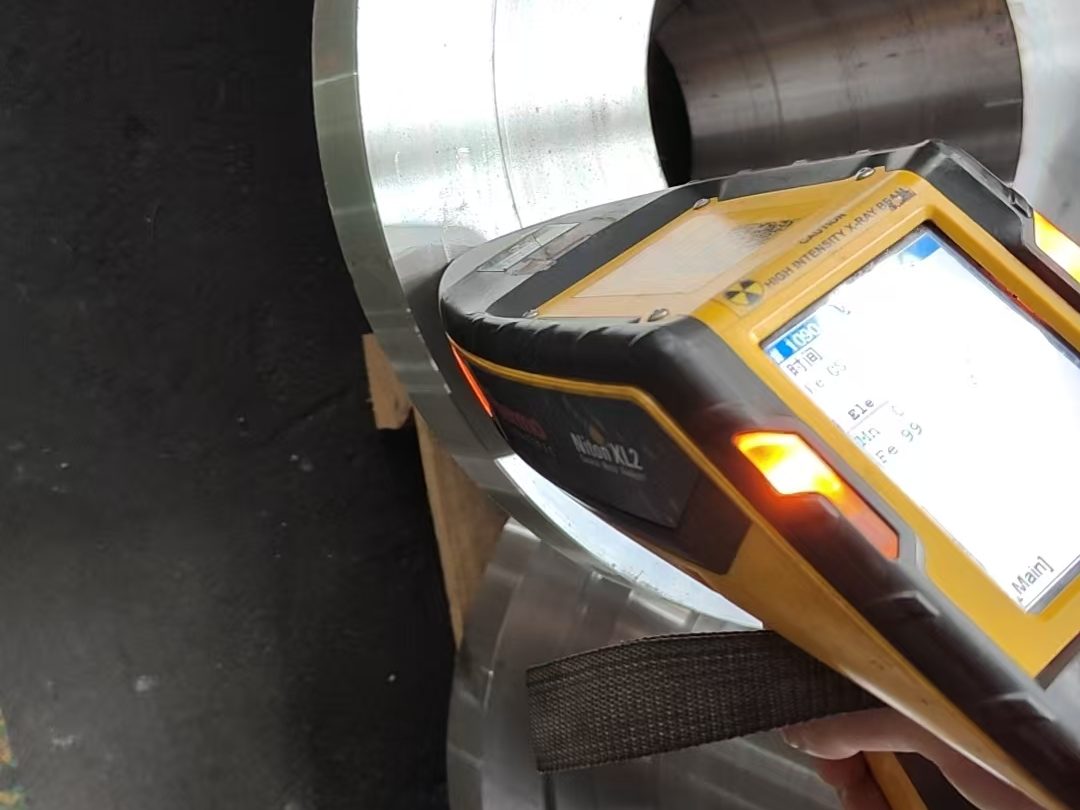 Re-verifying the material identity of finished forgings with a handheld XRF spectrometer before shipping